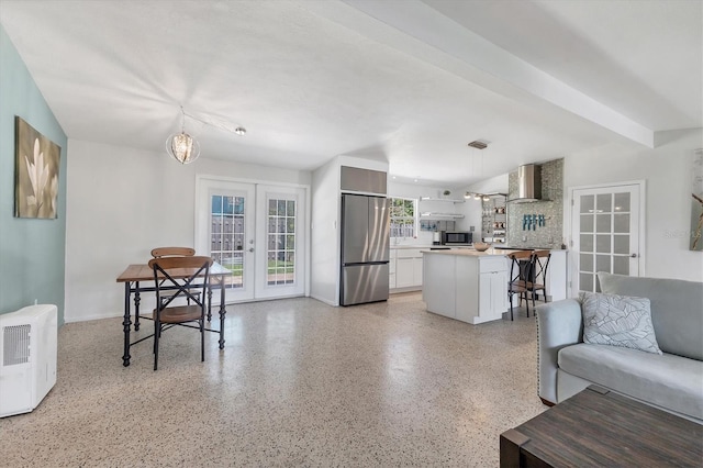 6931 Magellan Way, Sarasota, FL 34243 - living room featuring french doors, dark speckled floor, baseboards, and a chandelier