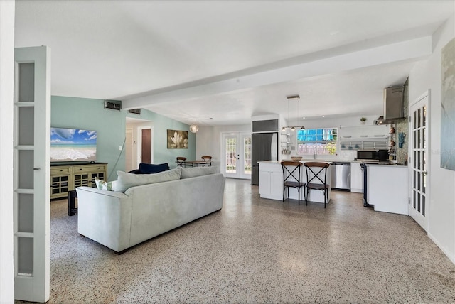 6931 Magellan Way, Sarasota, FL 34243 - living area featuring french doors and speckle patterned floor