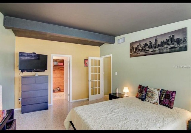 6931 Magellan Way, Sarasota, FL 34243 - bedroom with speckled floor, french doors, and baseboards