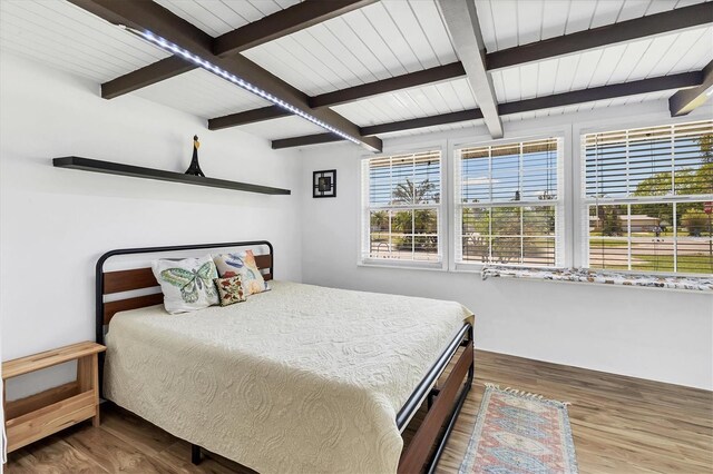 6931 Magellan Way, Sarasota, FL 34243 - bedroom with beam ceiling and wood finished floors