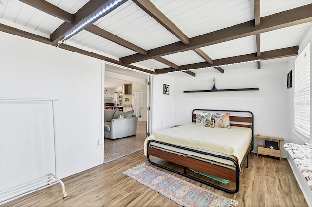 6931 Magellan Way, Sarasota, FL 34243 - bedroom with beam ceiling and wood finished floors