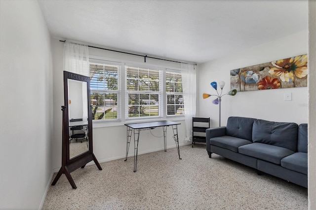6931 Magellan Way, Sarasota, FL 34243 - living room with speckled floor and baseboards