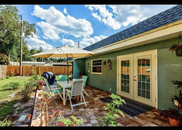 6931 Magellan Way, Sarasota, FL 34243 - view of patio with french doors, fence, and outdoor dining area