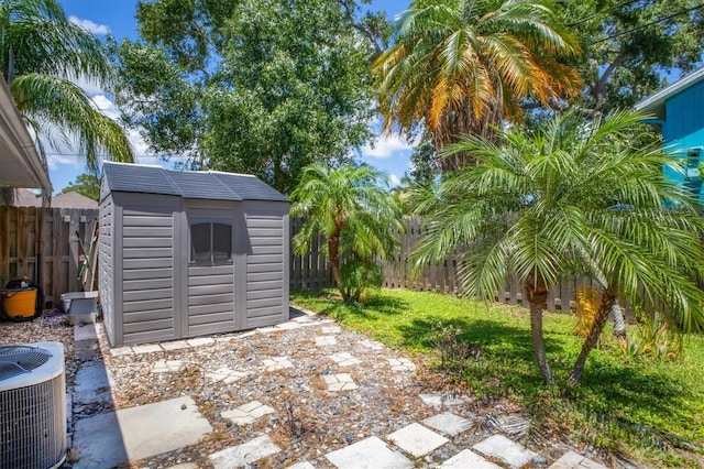 6931 Magellan Way, Sarasota, FL 34243 - fenced backyard featuring cooling unit, a storage shed, and an outdoor structure