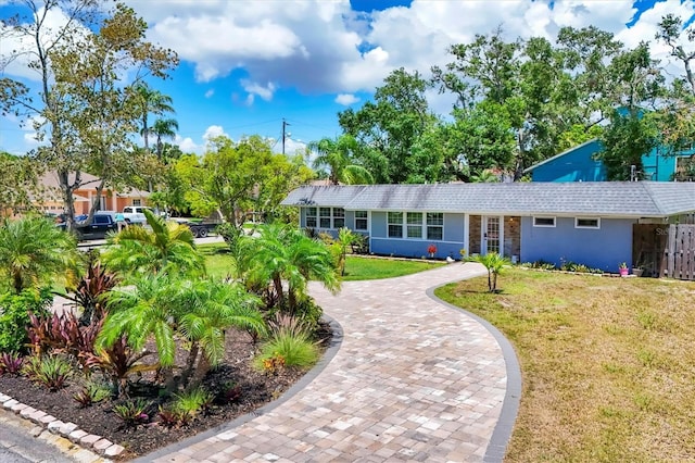 6931 Magellan Way, Sarasota, FL 34243 - single story home featuring a front yard, stucco siding, and decorative driveway