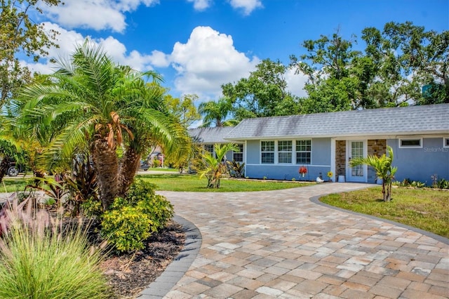 6931 Magellan Way, Sarasota, FL 34243 - single story home with stucco siding, decorative driveway, a front yard, and stone siding