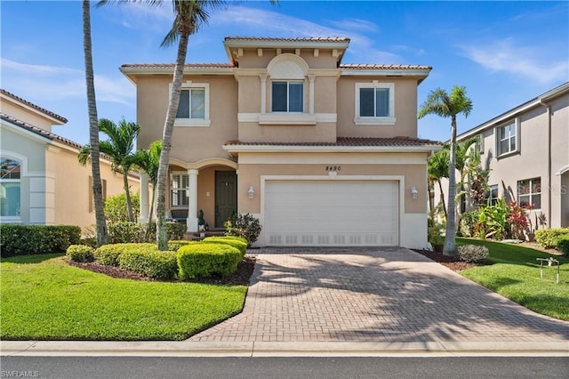 8490 Sumner Ave, Fort Myers, FL 33908 - mediterranean / spanish-style house featuring stucco siding, decorative driveway, a garage, a tiled roof, and a front yard