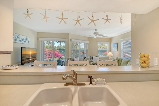 1226 Siesta Bayside Dr Unit 1226C, Sarasota, FL 34242 - kitchen featuring a sink, open floor plan, a ceiling fan, and light countertops