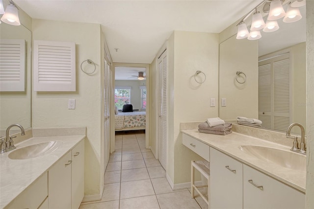1226 Siesta Bayside Dr Unit 1226C, Sarasota, FL 34242 - ensuite bathroom featuring tile patterned flooring, baseboards, two vanities, and a ceiling fan