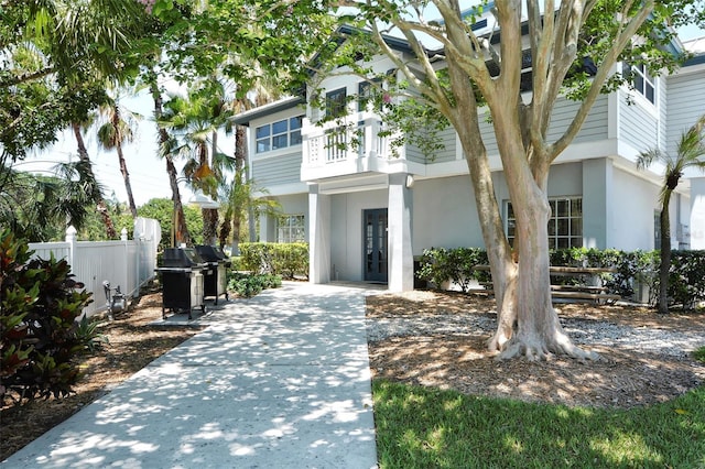 1226 Siesta Bayside Dr Unit 1226C, Sarasota, FL 34242 - view of front facade with stucco siding, french doors, fence, and a balcony