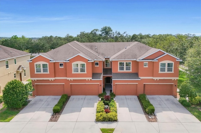 11507 84th Street Cir E Unit 102, Parrish, FL 34219 - view of front of home featuring stucco siding, a garage, and driveway
