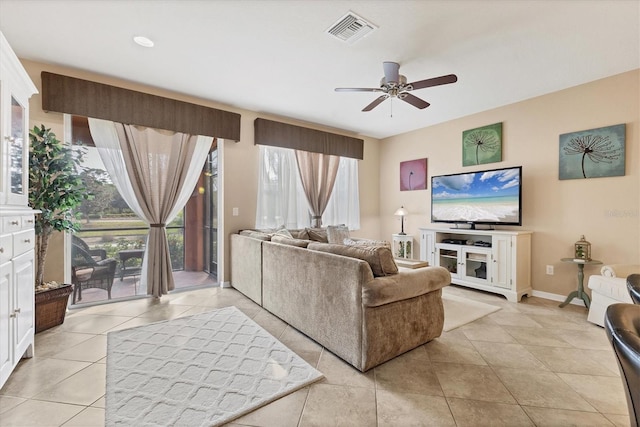 11507 84th Street Cir E Unit 102, Parrish, FL 34219 - living area with ceiling fan, light tile patterned floors, and baseboards