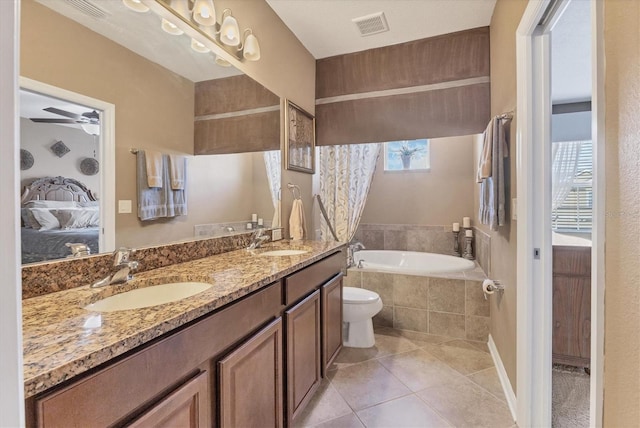 11507 84th Street Cir E Unit 102, Parrish, FL 34219 - bathroom featuring ensuite bath, a bath, tile patterned floors, double vanity, and a ceiling fan