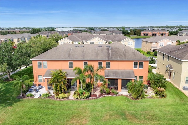11507 84th Street Cir E Unit 102, Parrish, FL 34219 - back of property with a residential view, a patio, a lawn, a sunroom, and stucco siding