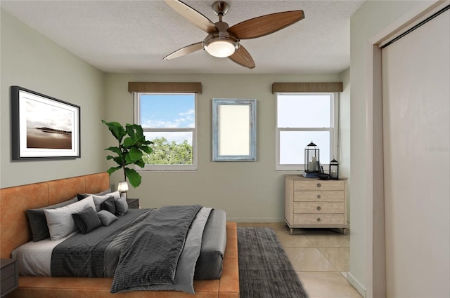 33 S Gulfstream Ave Unit 502, Sarasota, FL 34236 - bedroom featuring multiple windows, light tile patterned floors, a ceiling fan, and a textured ceiling