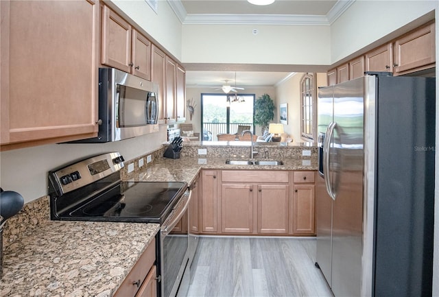 7005 River Hammock Dr Unit 204, Bradenton, FL 34212 - kitchen featuring stainless steel appliances, a sink, ornamental molding, light brown cabinets, and light stone countertops