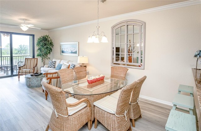 7005 River Hammock Dr Unit 204, Bradenton, FL 34212 - dining room featuring wood finished floors, ornamental molding, a ceiling fan, a chandelier, and baseboards