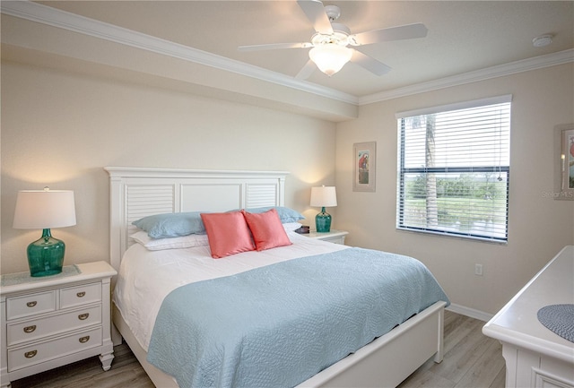 7005 River Hammock Dr Unit 204, Bradenton, FL 34212 - bedroom with light wood finished floors, crown molding, baseboards, and ceiling fan