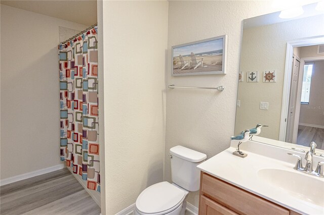 7005 River Hammock Dr Unit 204, Bradenton, FL 34212 - full bath with toilet, wood finished floors, vanity, and a shower with curtain