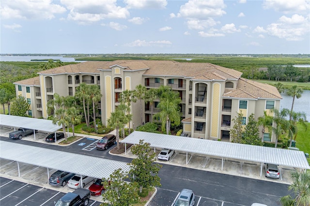 7005 River Hammock Dr Unit 204, Bradenton, FL 34212 - view of property with covered and uncovered parking and a water view