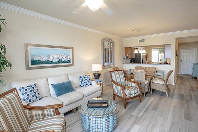 7005 River Hammock Dr Unit 204, Bradenton, FL 34212 - living area with crown molding, light wood finished floors, baseboards, a chandelier, and ceiling fan