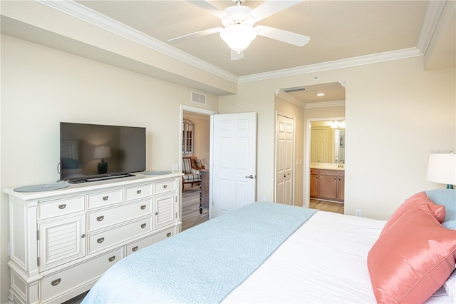 7005 River Hammock Dr Unit 204, Bradenton, FL 34212 - bedroom with ornamental molding, wood finished floors, ensuite bathroom, ceiling fan, and baseboards