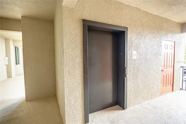 7005 River Hammock Dr Unit 204, Bradenton, FL 34212 - doorway to property with elevator and stucco siding