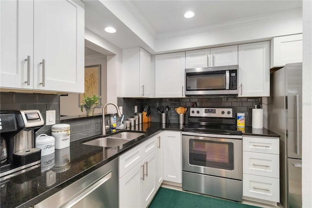 6999 W Country Club Dr N Unit 224, Sarasota, FL 34243 - kitchen featuring appliances with stainless steel finishes, a sink, white cabinetry, ornamental molding, and recessed lighting