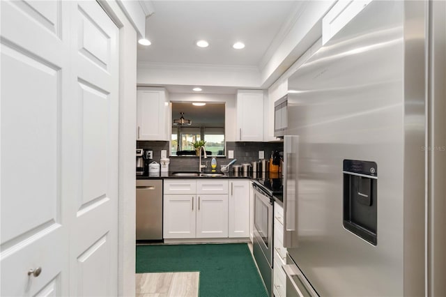 6999 W Country Club Dr N Unit 224, Sarasota, FL 34243 - kitchen with stainless steel appliances, a sink, ornamental molding, white cabinetry, and recessed lighting