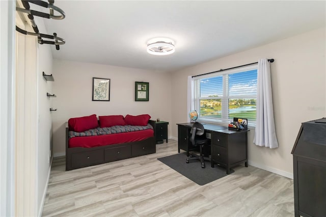 6999 W Country Club Dr N Unit 224, Sarasota, FL 34243 - bedroom featuring wood finished floors, baseboards, and an office area