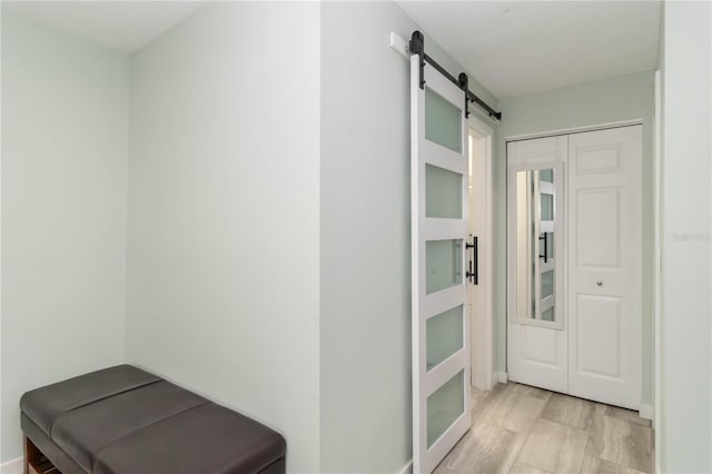 6999 W Country Club Dr N Unit 224, Sarasota, FL 34243 - corridor featuring a barn door and baseboards
