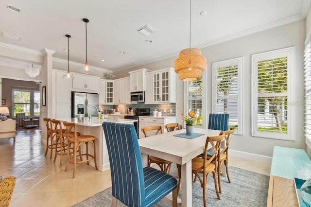 311 Compass Point Dr Unit 101, Bradenton, FL 34209 - dining space featuring crown molding, light tile patterned floors, and baseboards