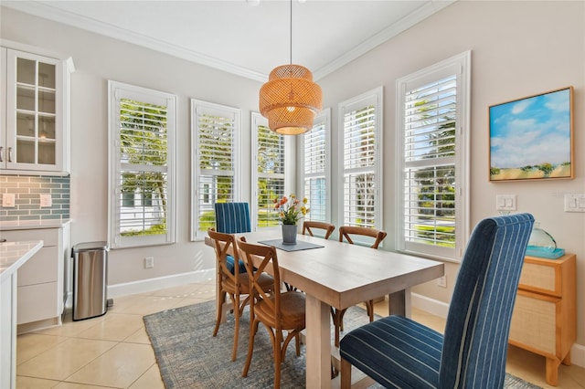 311 Compass Point Dr Unit 101, Bradenton, FL 34209 - dining space with healthy amount of natural light, light tile patterned flooring, ornamental molding, and baseboards