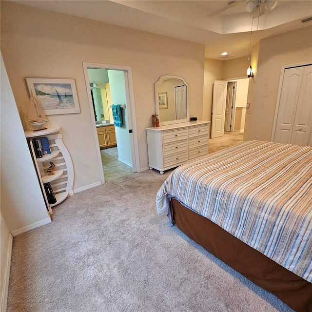 8110 Villa Grande Ct, Sarasota, FL 34243 - bedroom with light colored carpet, baseboards, a closet, and ensuite bath