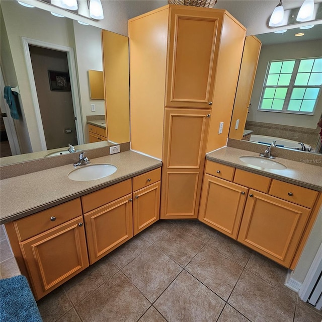 8110 Villa Grande Ct, Sarasota, FL 34243 - bathroom with two vanities, tile patterned flooring, and a tub