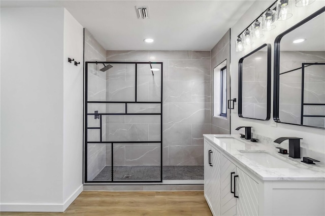 3239 Daytona Dr, Punta Gorda, FL 33983 - bathroom featuring a stall shower, wood finished floors, recessed lighting, and double vanity