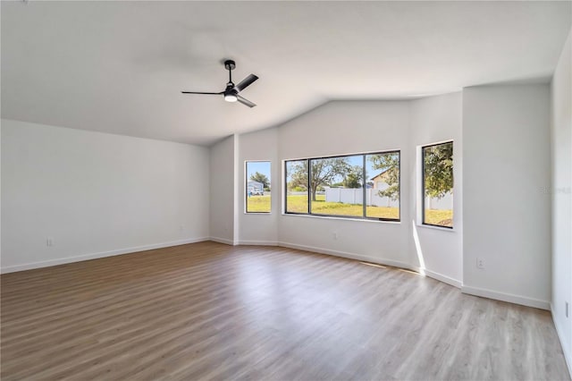 3239 Daytona Dr, Punta Gorda, FL 33983 - empty room featuring ceiling fan, wood finished floors, vaulted ceiling, and baseboards