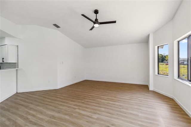 3239 Daytona Dr, Punta Gorda, FL 33983 - unfurnished living room featuring lofted ceiling, ceiling fan, light wood-type flooring, and baseboards
