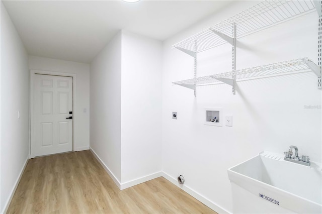 3239 Daytona Dr, Punta Gorda, FL 33983 - laundry area with light wood finished floors, baseboards, hookup for an electric dryer, and washer hookup