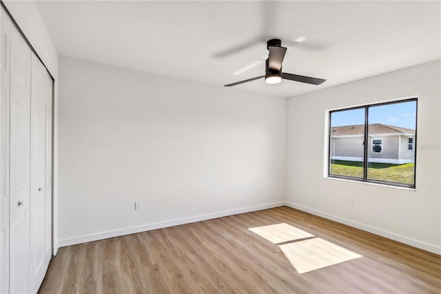 3239 Daytona Dr, Punta Gorda, FL 33983 - unfurnished bedroom featuring a closet, wood finished floors, baseboards, and ceiling fan