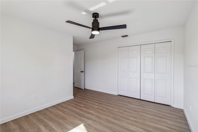 3239 Daytona Dr, Punta Gorda, FL 33983 - unfurnished bedroom with baseboards, light wood-style floors, and a closet