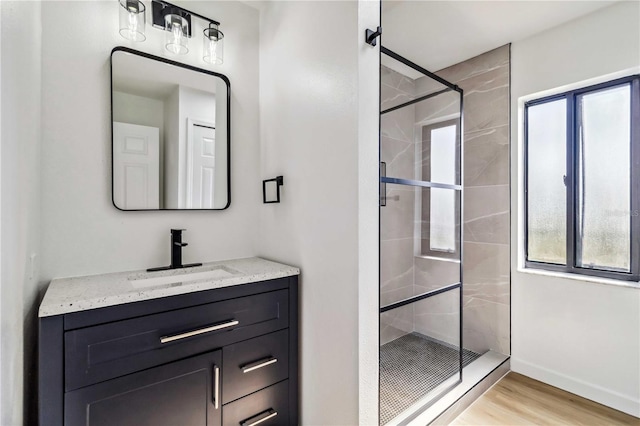 3239 Daytona Dr, Punta Gorda, FL 33983 - bathroom with a shower stall, wood finished floors, vanity, and baseboards