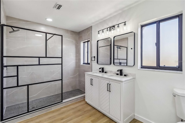 3239 Daytona Dr, Punta Gorda, FL 33983 - full bathroom with a tile shower, toilet, and wood finished floors