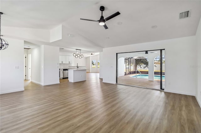 3239 Daytona Dr, Punta Gorda, FL 33983 - unfurnished living room with a chandelier, ceiling fan, high vaulted ceiling, light wood-type flooring, and baseboards