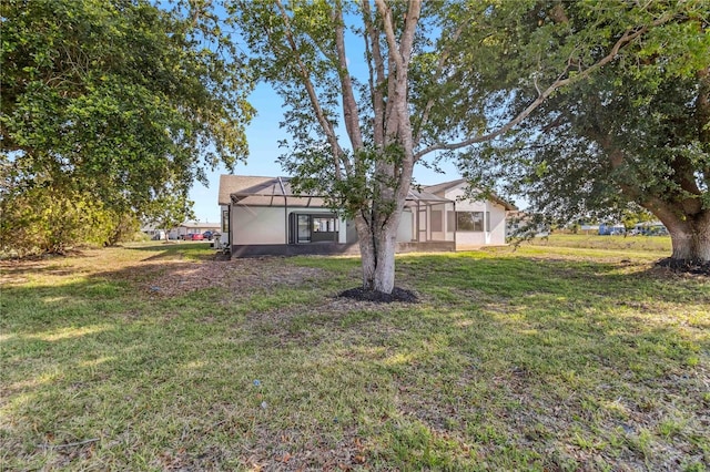 3239 Daytona Dr, Punta Gorda, FL 33983 - view of grassy yard featuring glass enclosure