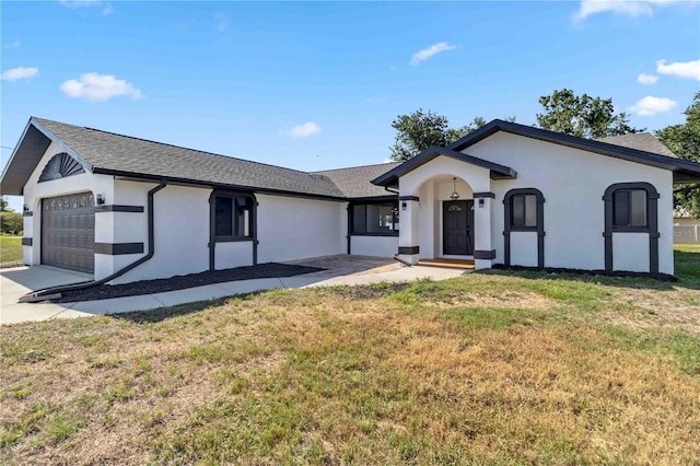 3239 Daytona Dr, Punta Gorda, FL 33983 - view of front of house with stucco siding, a garage, a front yard, roof with shingles, and concrete driveway