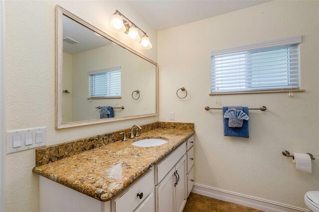 112 Palm Ave, Anna Maria, FL 34216 - bathroom with vanity, toilet, and baseboards