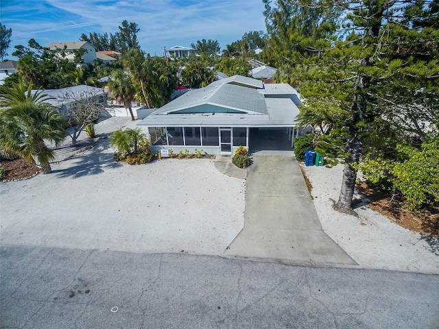 112 Palm Ave, Anna Maria, FL 34216 - view of front of house featuring a sunroom and driveway