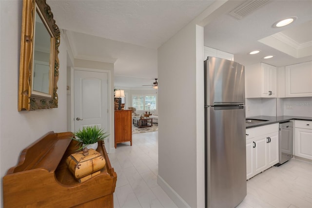 1350 N Portofino Dr Unit 208, Sarasota, FL 34242 - kitchen with stainless steel appliances, white cabinets, recessed lighting, dark countertops, and baseboards