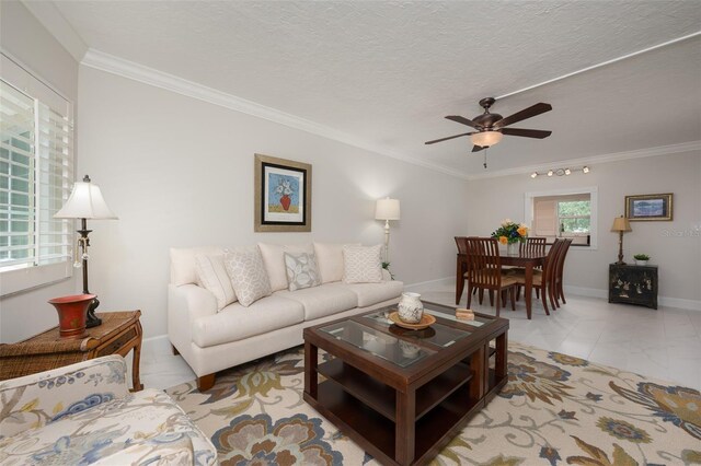 1350 N Portofino Dr Unit 208, Sarasota, FL 34242 - living area with ceiling fan, crown molding, baseboards, and light marble finish flooring
